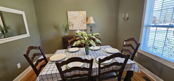 a view of a dining room with furniture and window