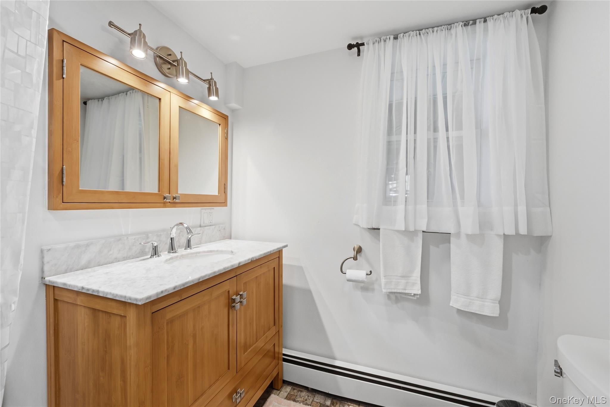 35 Randall Road Shoreham, NY 11786 - Photo 20 of 32 a bathroom with a sink and a mirror