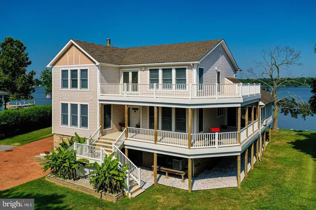 a front view of a house with a yard table and chairs