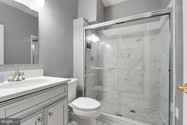 a kitchen with stainless steel appliances granite countertop a stove a sink and white cabinets