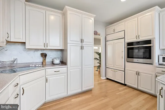 a living room with furniture a fireplace and a chandelier