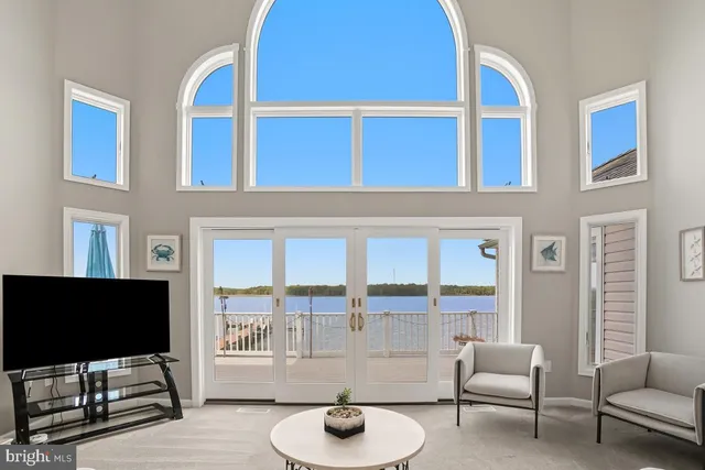 a spacious bedroom with a bed and ceiling fan