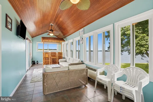 a view of a deck with wooden floor and outdoor seating