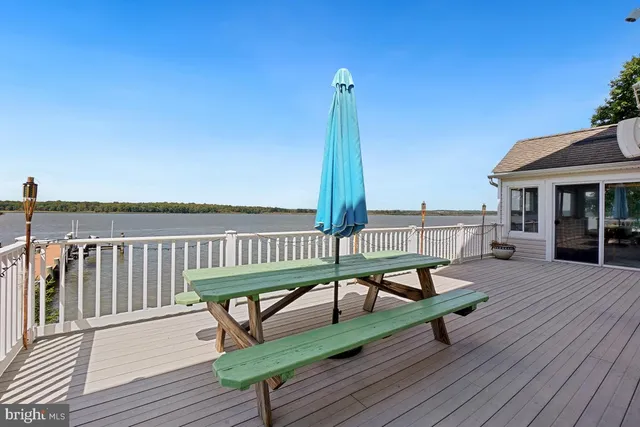 a bathroom with a granite countertop sink a toilet a mirror and shower