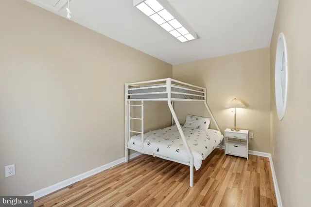 a bathroom with a granite countertop sink mirror and toilet
