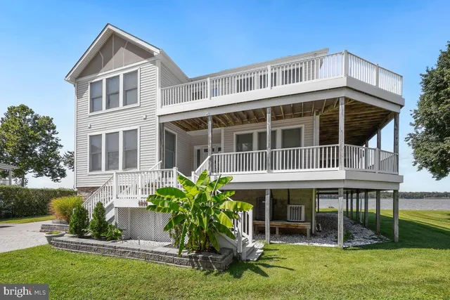 a view of a porch with furniture and floor to ceiling window
