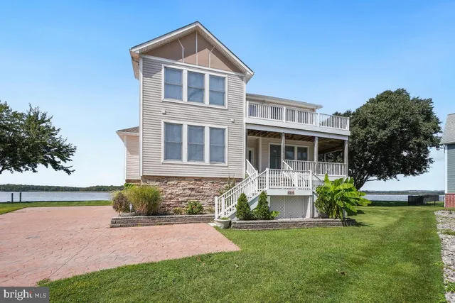 a living room with furniture and large windows