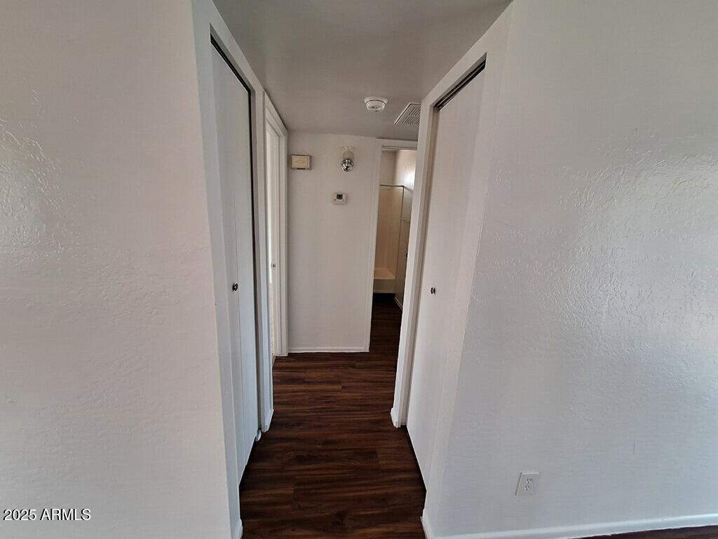 2029 North Hunt Circle, Unit 202 Mesa, AZ 85203 - Photo 3 of 9 a view of a hallway with wooden floor and staircase