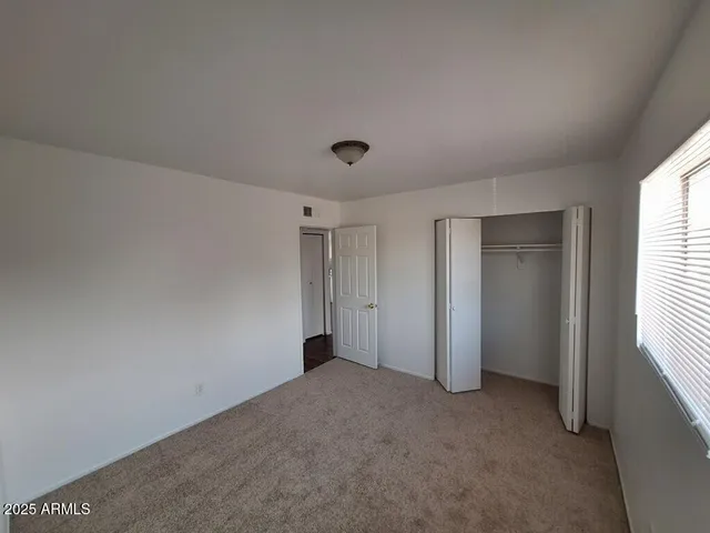 a view of an empty room and a window