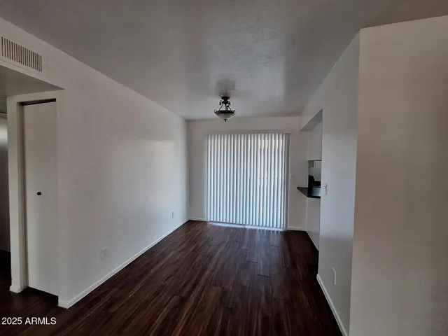 a view of a room with wooden floor and a window
