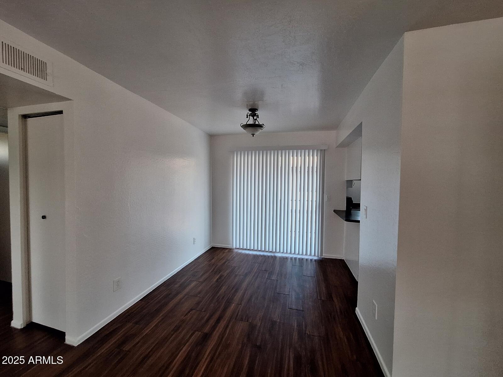 2029 North Hunt Circle, Unit 202 Mesa, AZ 85203 - Photo 6 of 9 a view of a room with wooden floor and a window