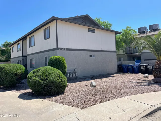 a view of a house with a small yard and plants