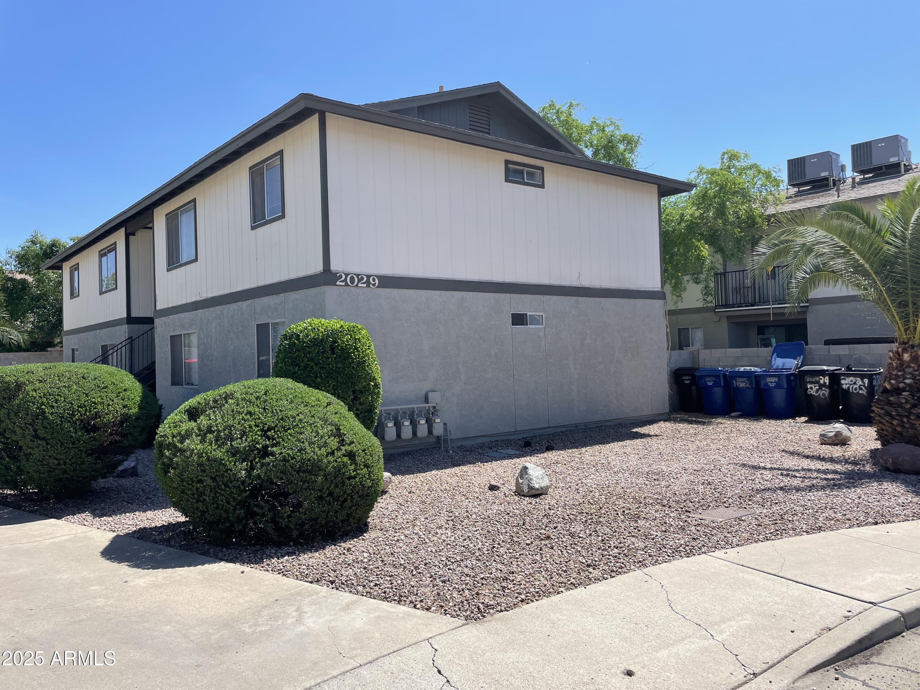 2029 North Hunt Circle, Unit 202 Mesa, AZ 85203 - Photo 9 of 9 a view of a house with a small yard and plants