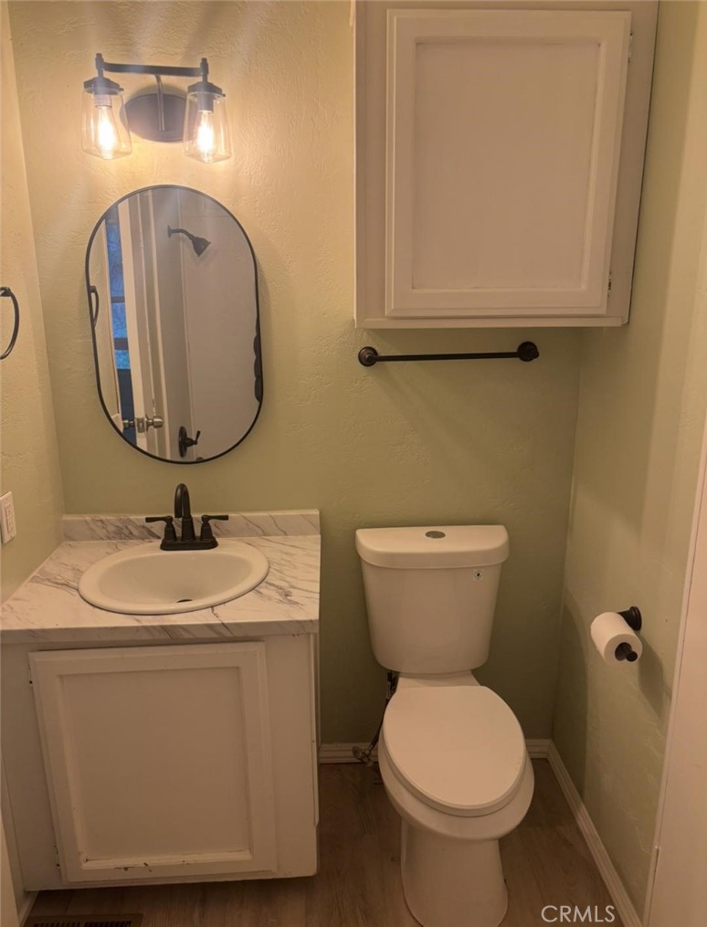 18266 Caliente Creek Road Caliente, CA 93518 - Photo 15 of 38 a bathroom with a toilet sink and mirror