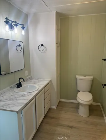 a view of a dry yard with trees all around