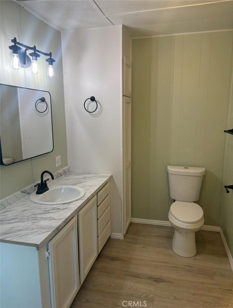 18266 Caliente Creek Road Caliente, CA 93518 - Photo 9 of 38 a bathroom with a granite countertop sink toilet and a mirror