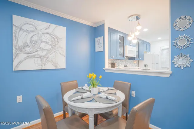 a kitchen with a sink cabinets stainless steel appliances and wooden floor