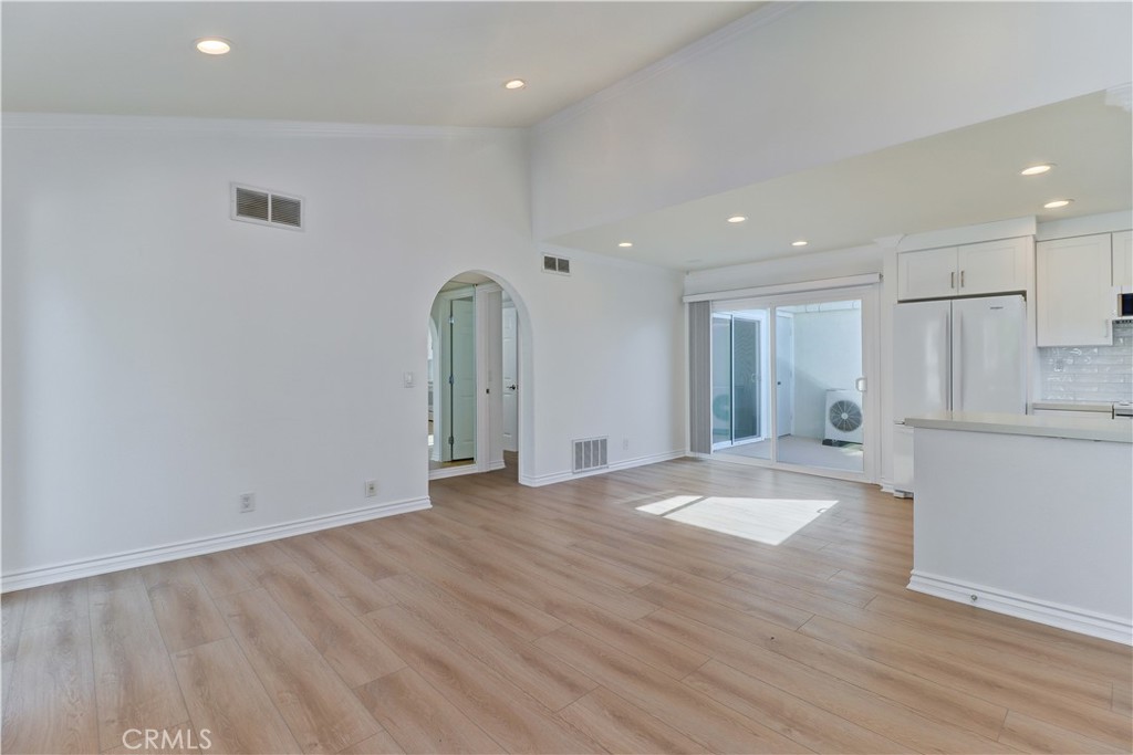 34026 Selva Road, Unit 65 Dana Point, CA 92629 - Photo 2 of 21 a view of an empty room with wooden floor and a window