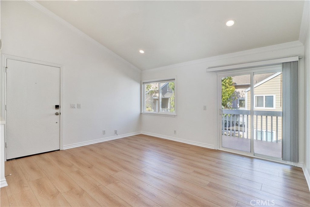 34026 Selva Road, Unit 65 Dana Point, CA 92629 - Photo 4 of 21 a view of an empty room with wooden floor and a window