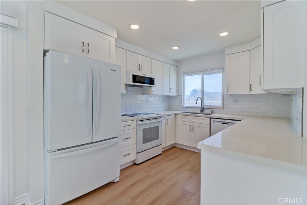 34026 Selva Road, Unit 65 Dana Point, CA 92629 - Photo 7 of 21 a kitchen with white cabinets and white appliances