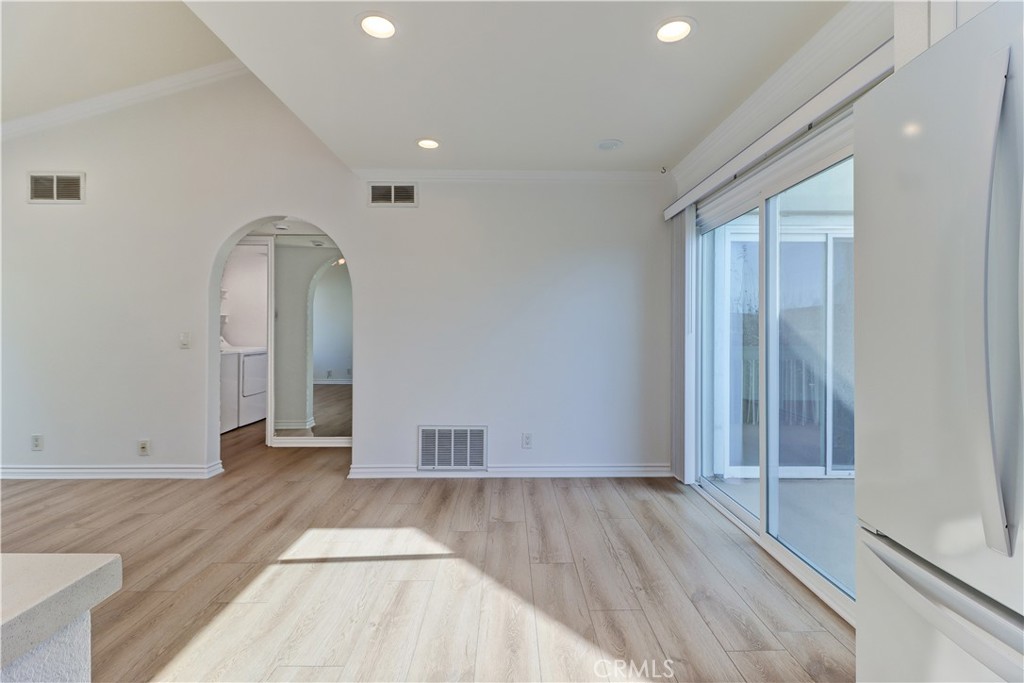 34026 Selva Road, Unit 65 Dana Point, CA 92629 - Photo 8 of 21 an empty room with wooden floor and mirror