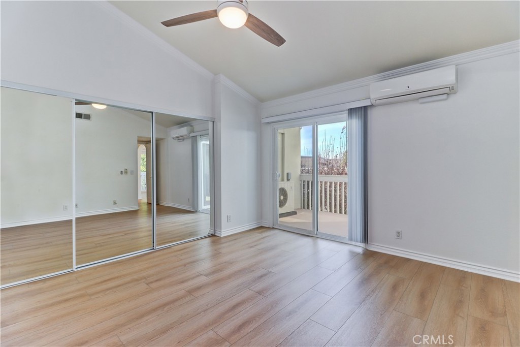 34026 Selva Road, Unit 65 Dana Point, CA 92629 - Photo 9 of 21 a view of an empty room with wooden floor and a window