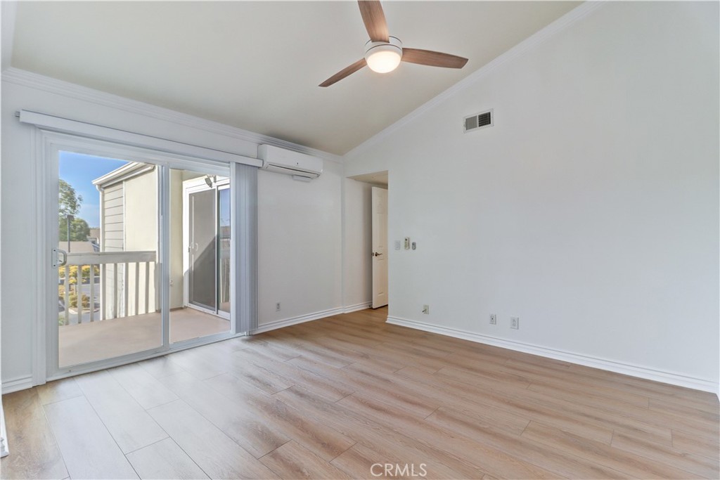 34026 Selva Road, Unit 65 Dana Point, CA 92629 - Photo 10 of 21 a view of an empty room with wooden floor and a window