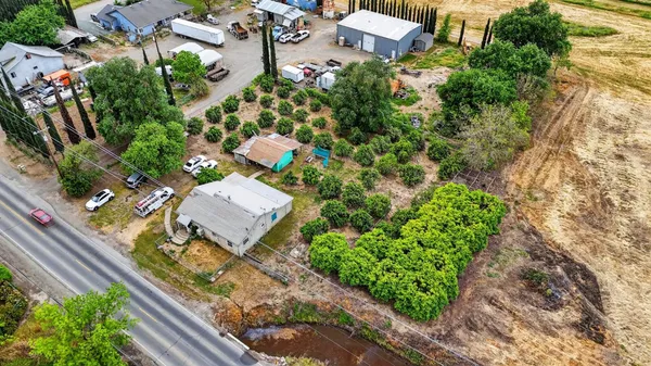 an aerial view of a house with a yard and garden