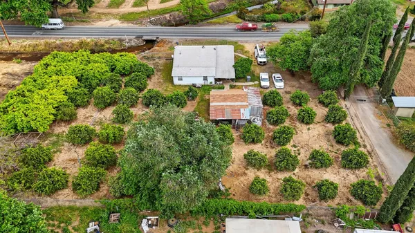 an aerial view of a house with a yard and garden