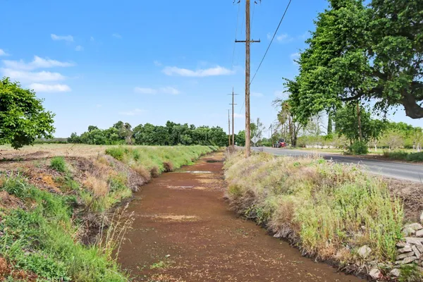 a view of a street with a yard
