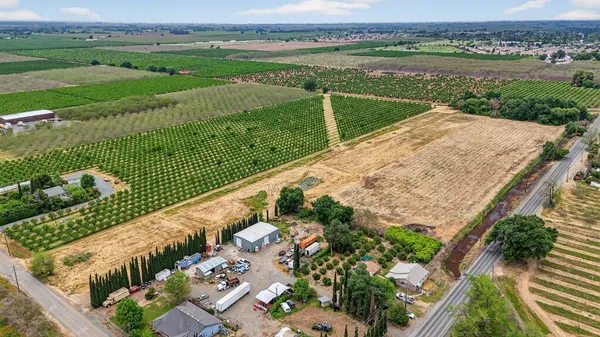 an aerial view of a house with a yard and lake view