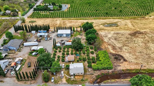 an aerial view of a house with a yard