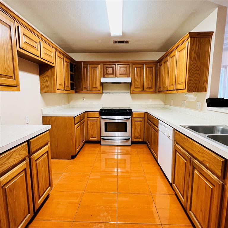 5022 El Sol Street Dallas, TX 75236 - Photo 6 of 16 a kitchen with stainless steel appliances granite countertop a stove and a sink