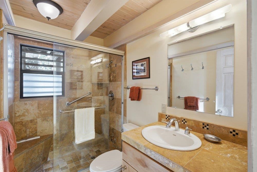 1499 Sandy Way Olympic Valley, CA 96146 - Photo 18 of 28 a bathroom with a granite countertop sink toilet a mirror and shower