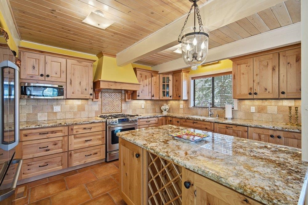 1499 Sandy Way Olympic Valley, CA 96146 - Photo 9 of 28 a kitchen with stainless steel appliances granite countertop a sink a stove and a wooden cabinets