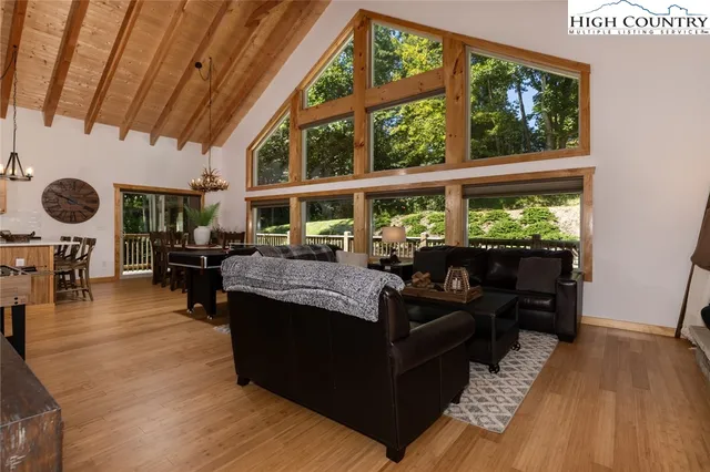 a kitchen with stainless steel appliances granite countertop a refrigerator oven a sink dishwasher and a stove with wooden floor