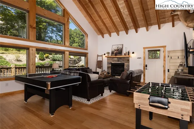 a living room with large windows and wooden floor