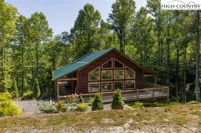 a living room with furniture a fireplace and a floor to ceiling window