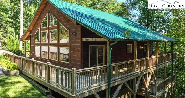 a kitchen with stainless steel appliances granite countertop a table chairs and a refrigerator