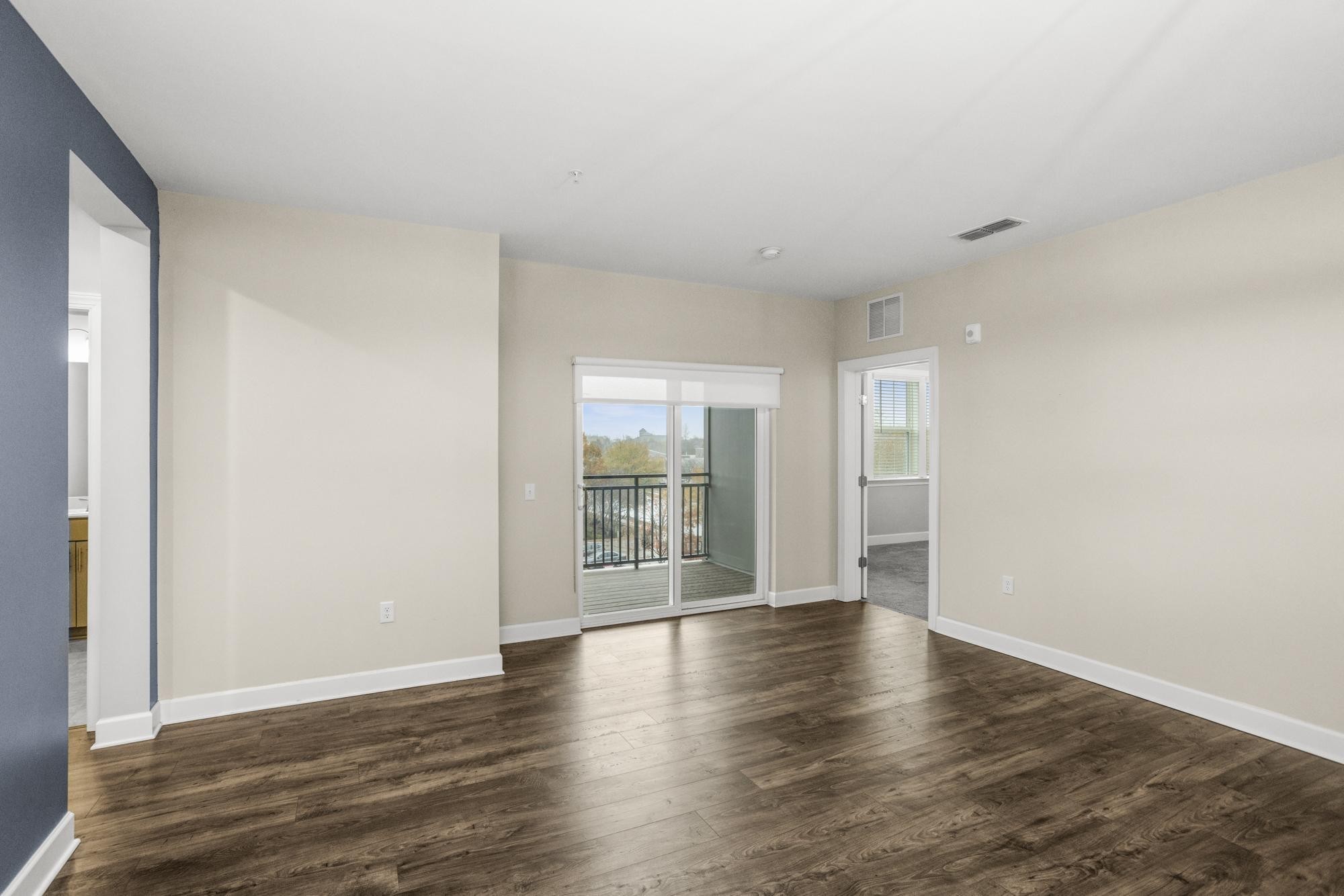 141 Saundersville Road, Unit 1402 Hendersonville, TN 37075 - Photo 12 of 60 a view of an empty room with wooden floor and a window