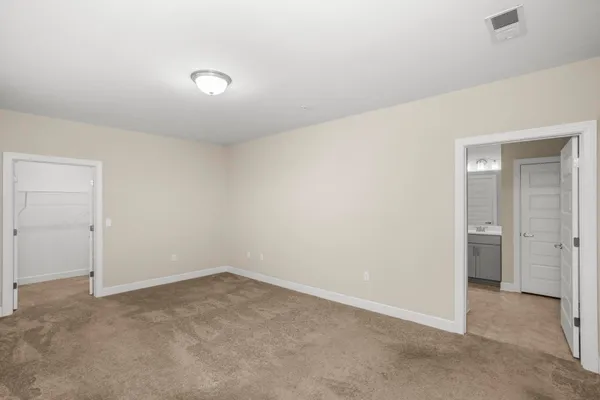 an empty room with a empty space and windows