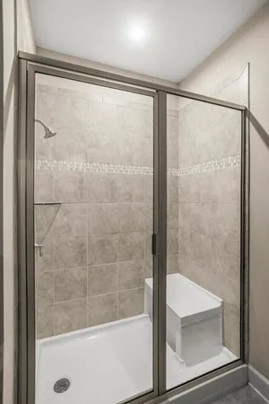 a bathroom with a glass shower door