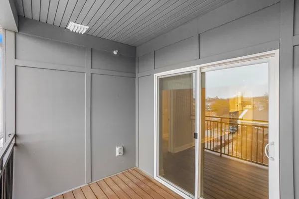 a view of a room with wooden floor windows and a chandelier