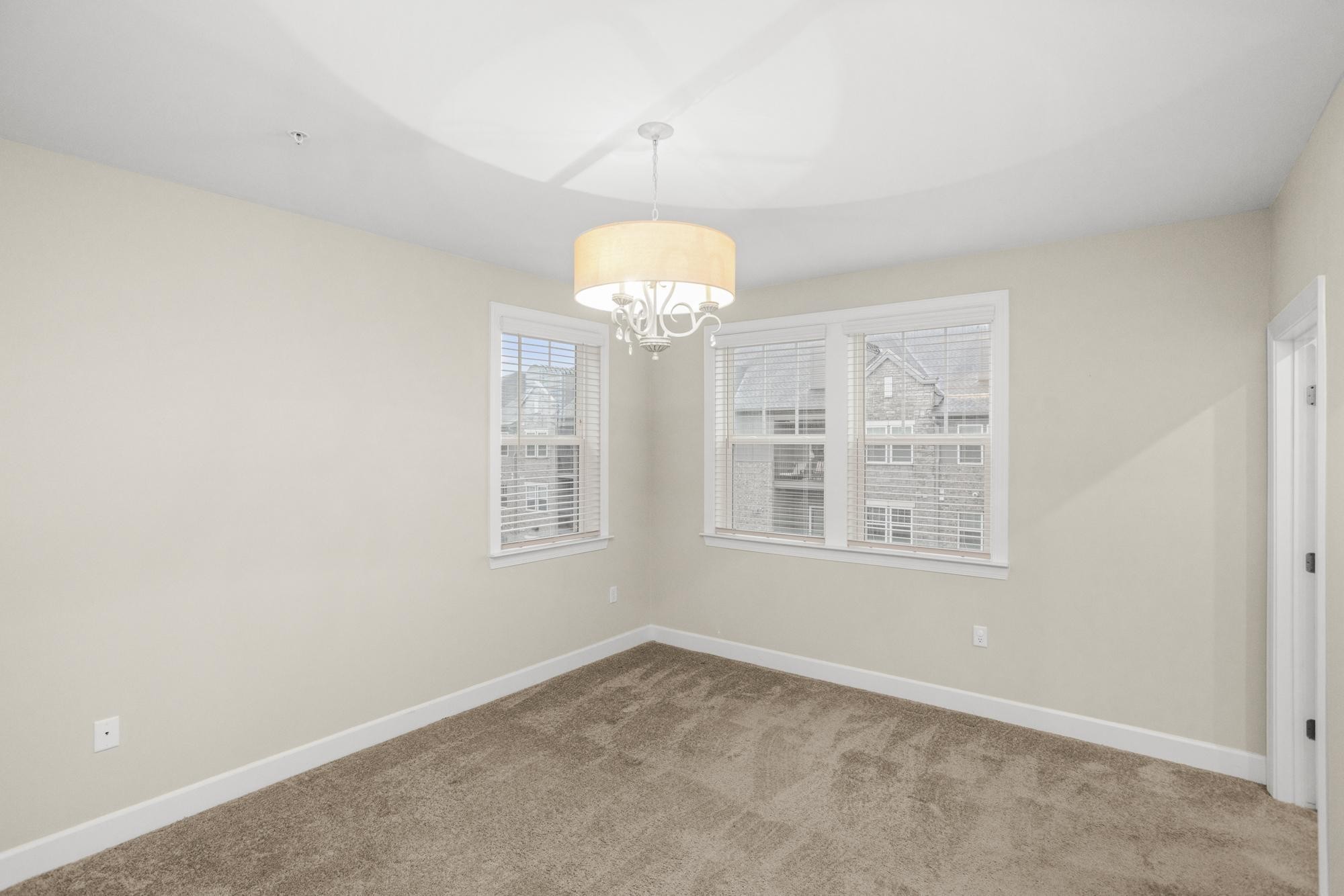 141 Saundersville Road, Unit 1402 Hendersonville, TN 37075 - Photo 30 of 60 an empty room with a chandelier fan and windows