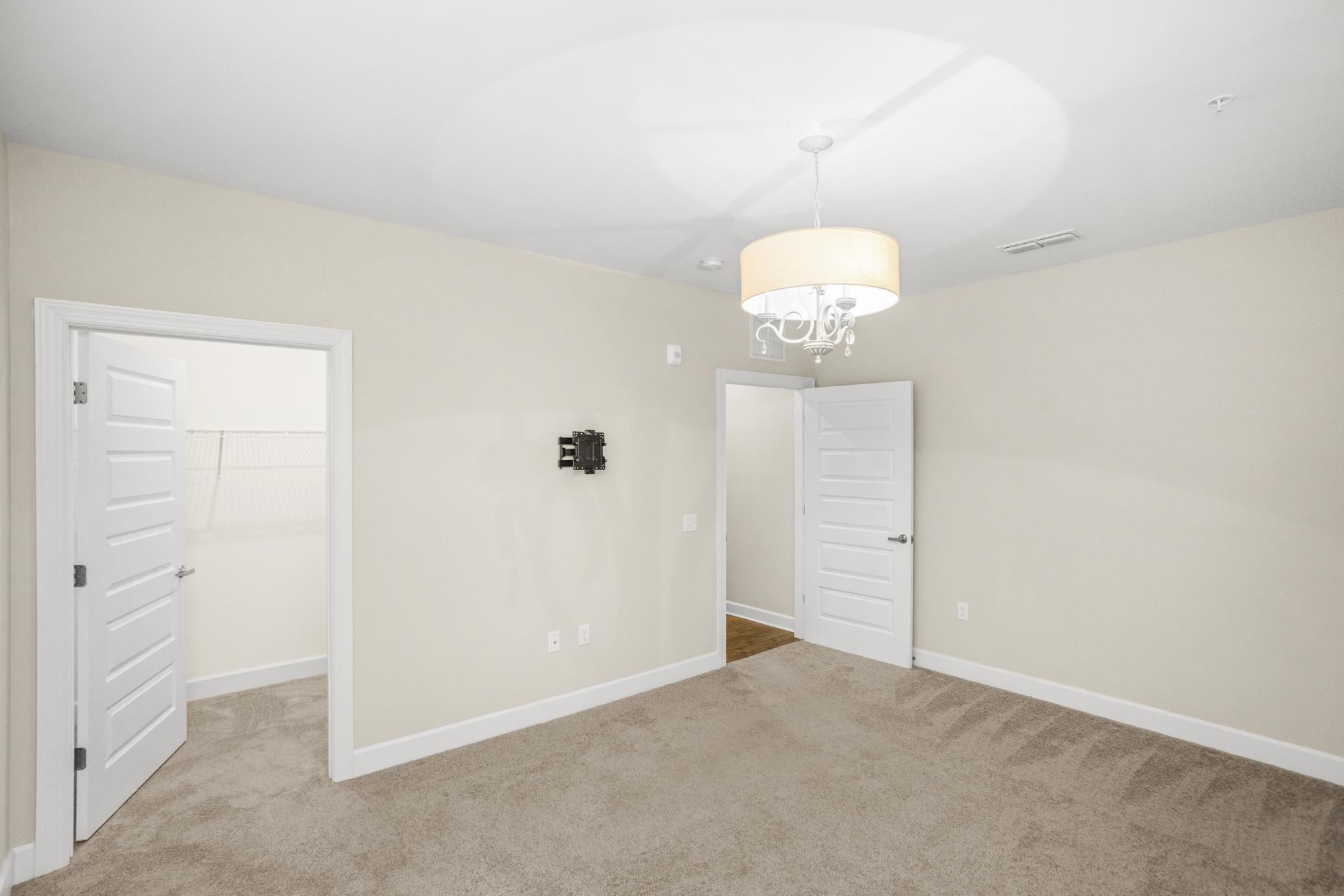 141 Saundersville Road, Unit 1402 Hendersonville, TN 37075 - Photo 32 of 60 an empty room with a chandelier fan