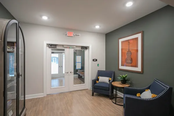 a hallway with dining area and chandelier