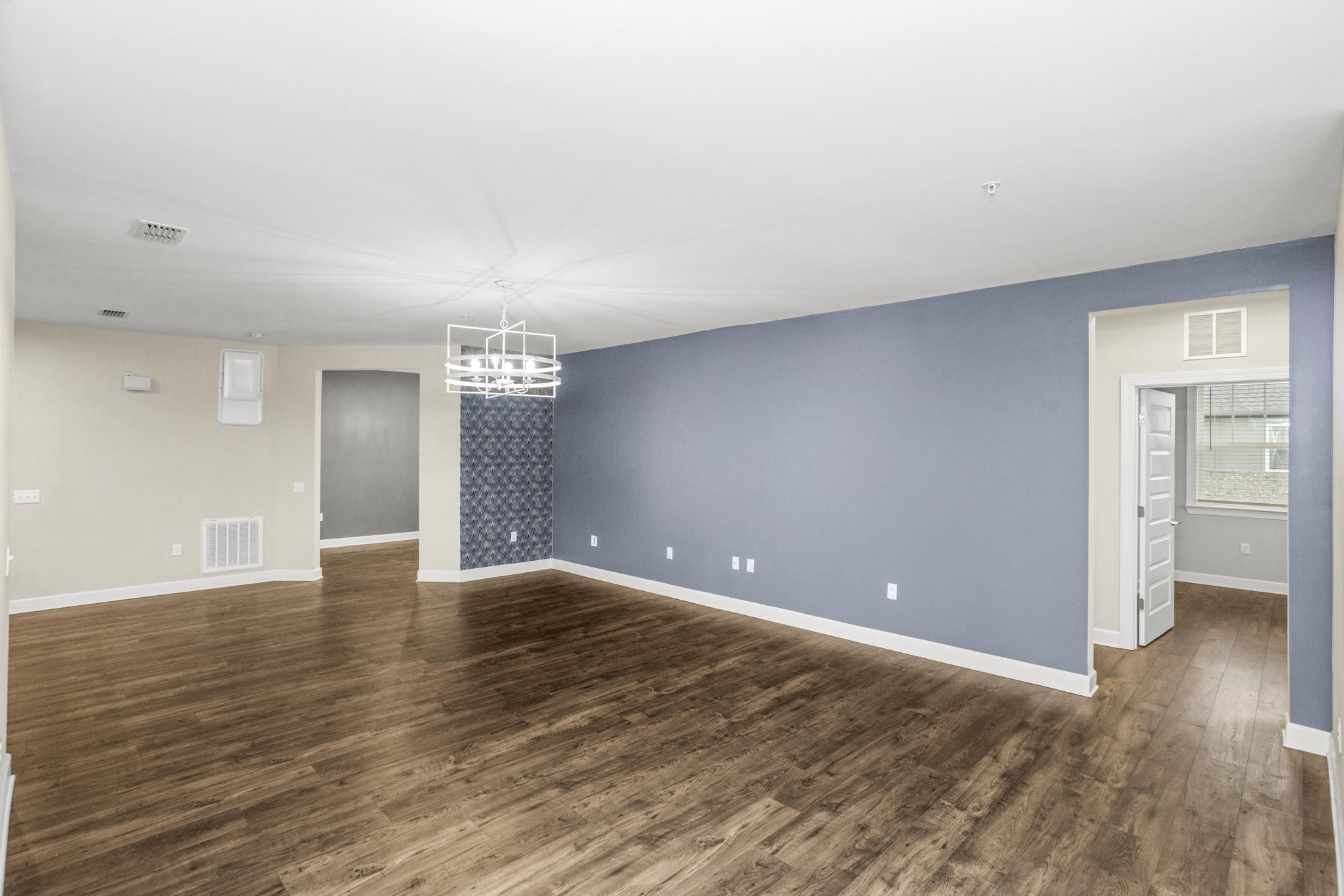 141 Saundersville Road, Unit 1402 Hendersonville, TN 37075 - Photo 9 of 60 a view of an empty room with window and wooden floor