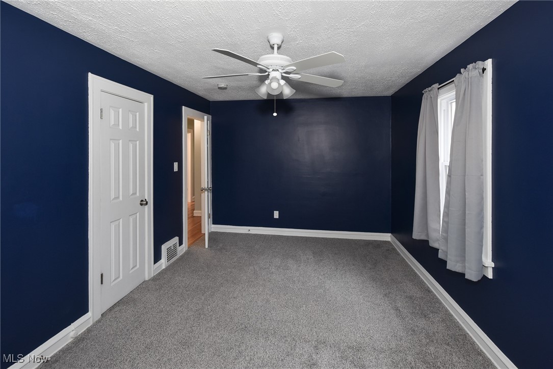 3631 Cummings Road Cleveland, OH 44118 - Photo 20 of 29 Carpeted empty room with a textured ceiling and a ceiling fan