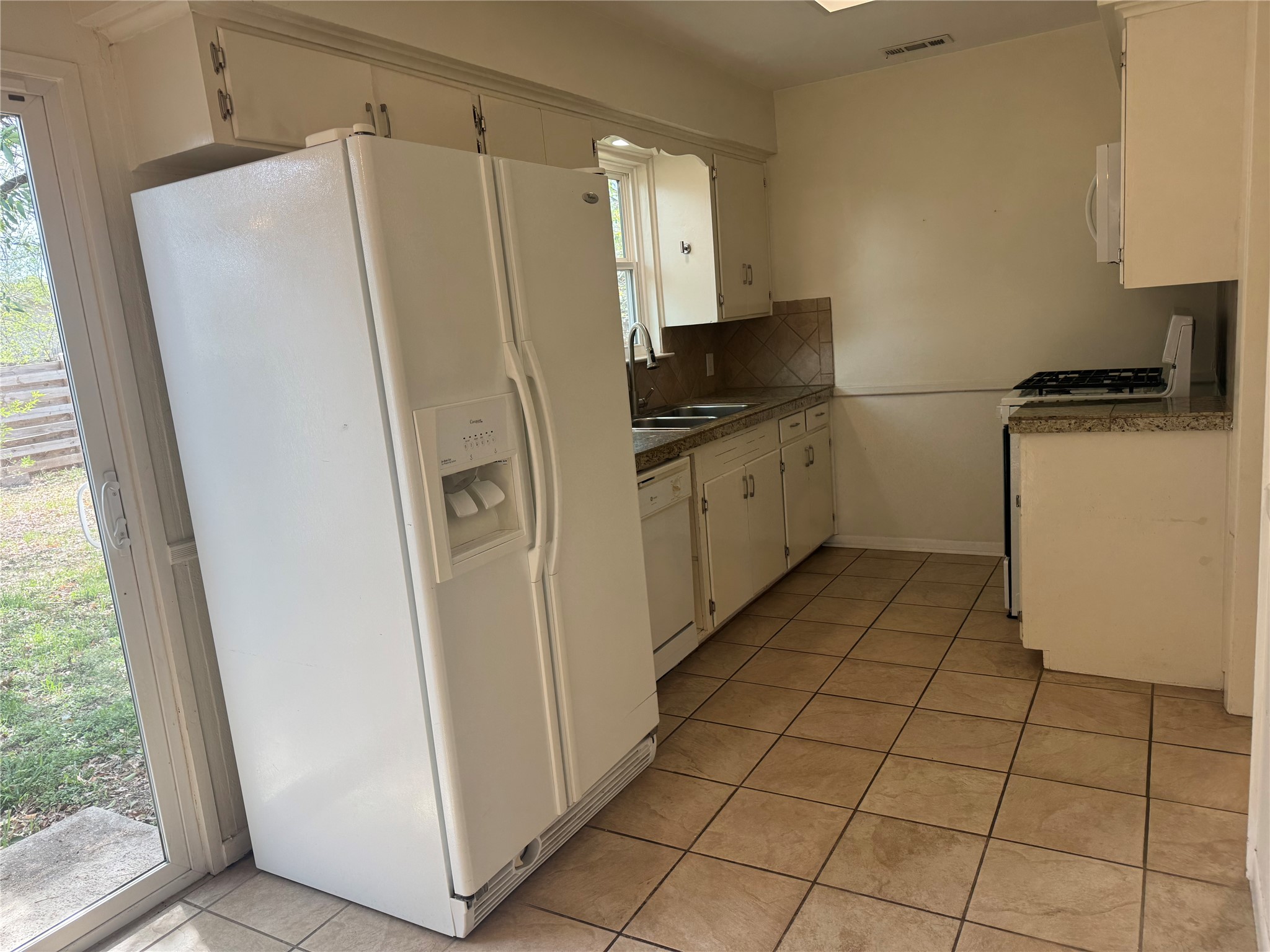 8017 Tisdale Drive Austin, TX 78757 - Photo 2 of 7 a kitchen with a refrigerator and a stove