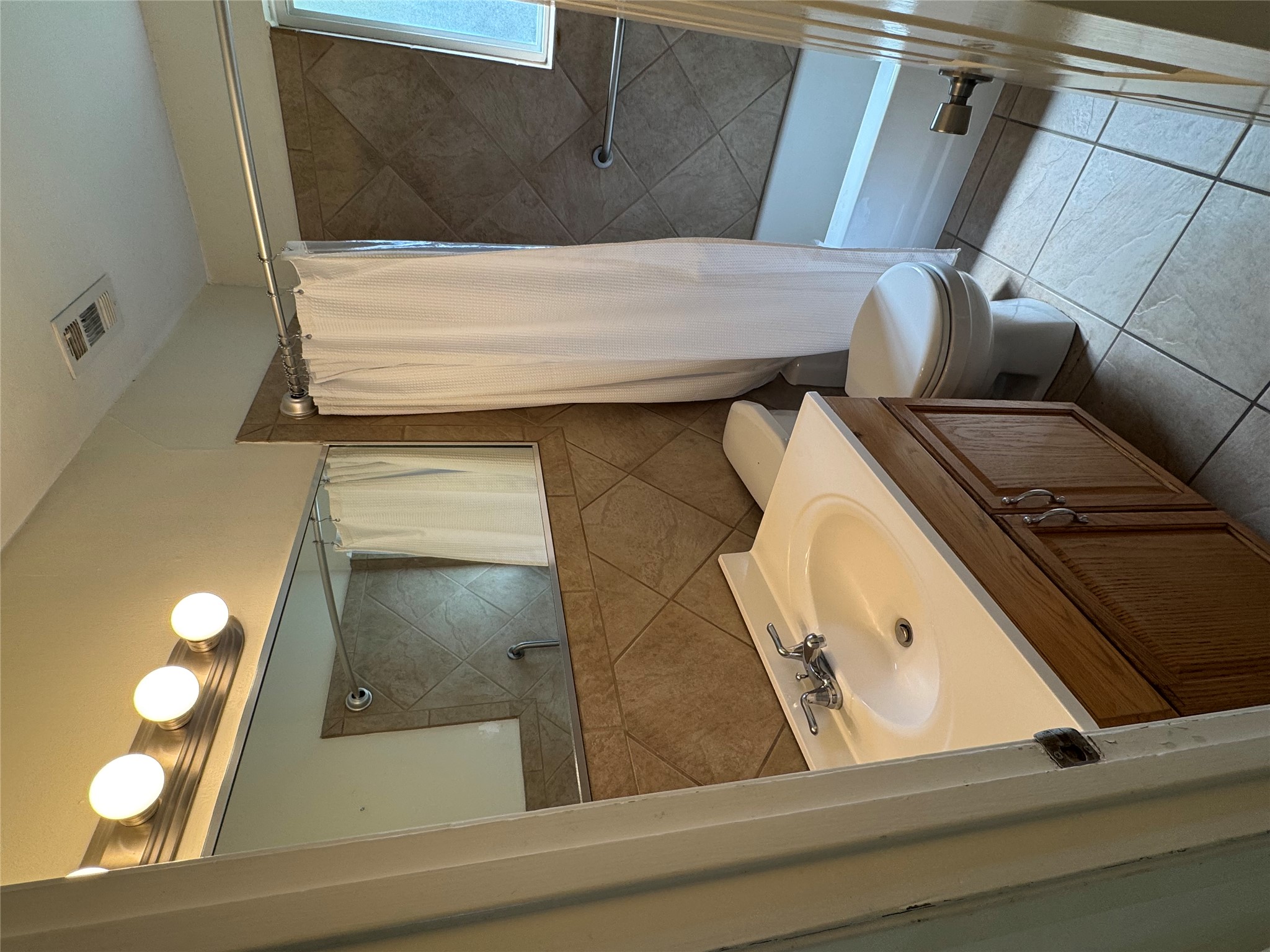 8017 Tisdale Drive Austin, TX 78757 - Photo 4 of 7 a bathroom with a sink toilet and shower